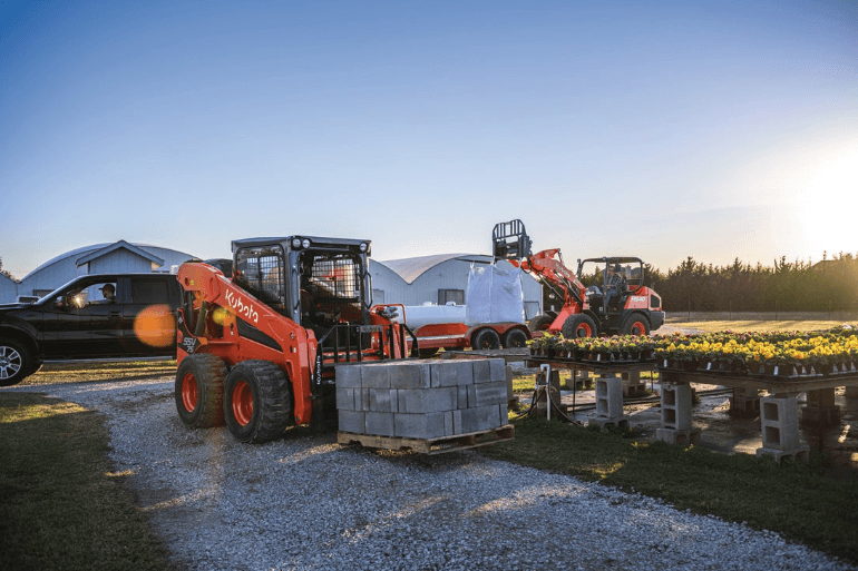 Skid Steer moving pallet of cinder blocks