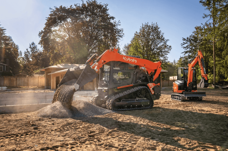 Track Loader dumping gravel on a construction site