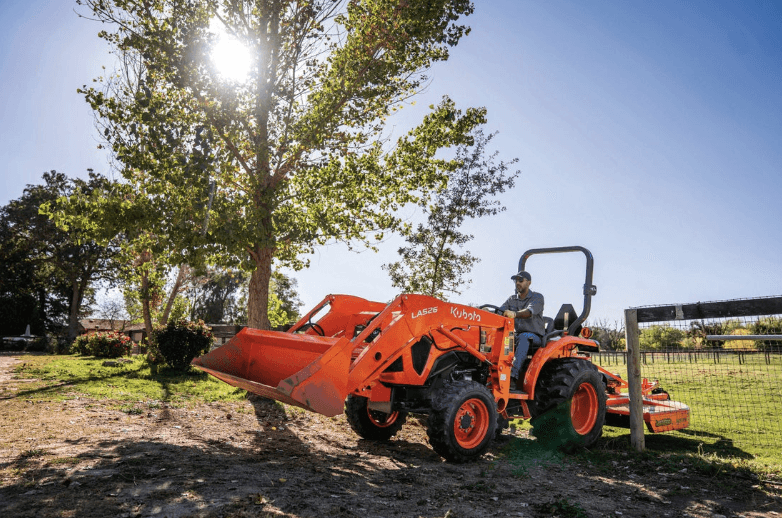 Kubota tractor driving through a gate
