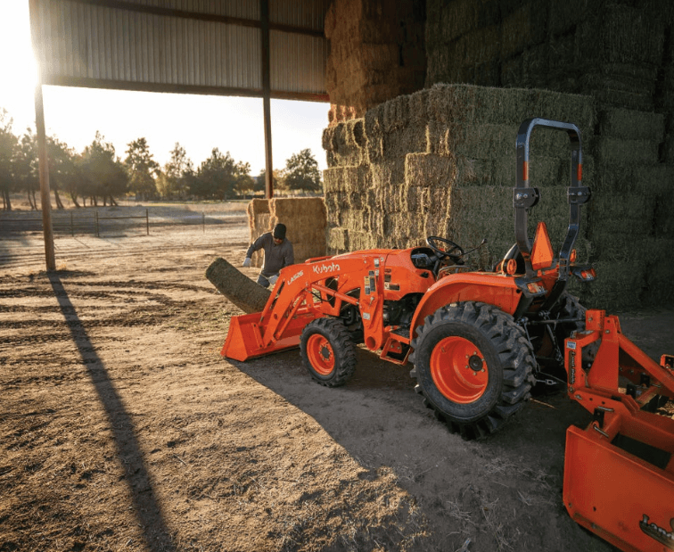 A woman loading up the front end with hay