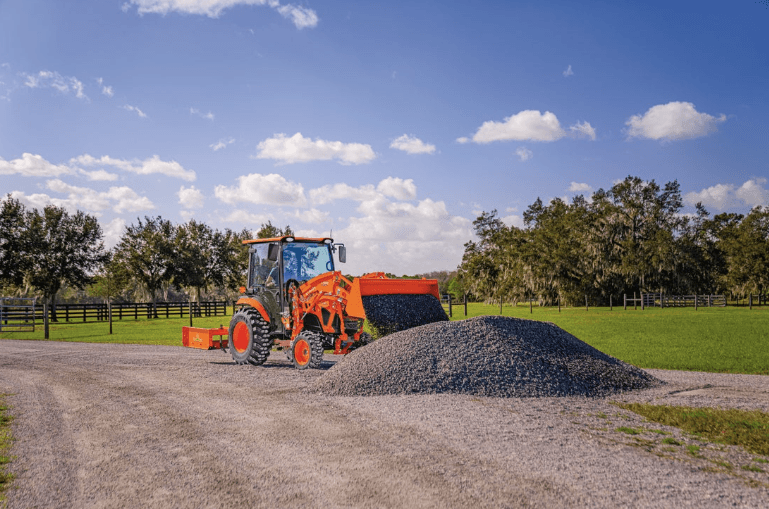 Tractor scooping up gravel from a pile