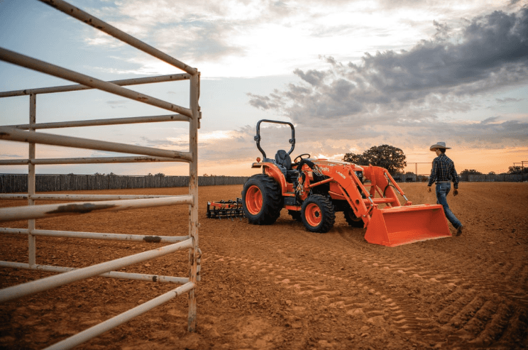 Man walking along side tractor