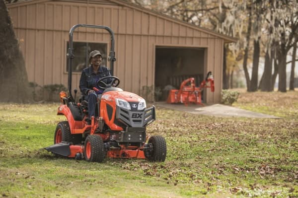 Woman driving a sub-compact tractor