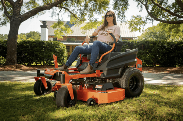 Woman posing with a bad boy mower