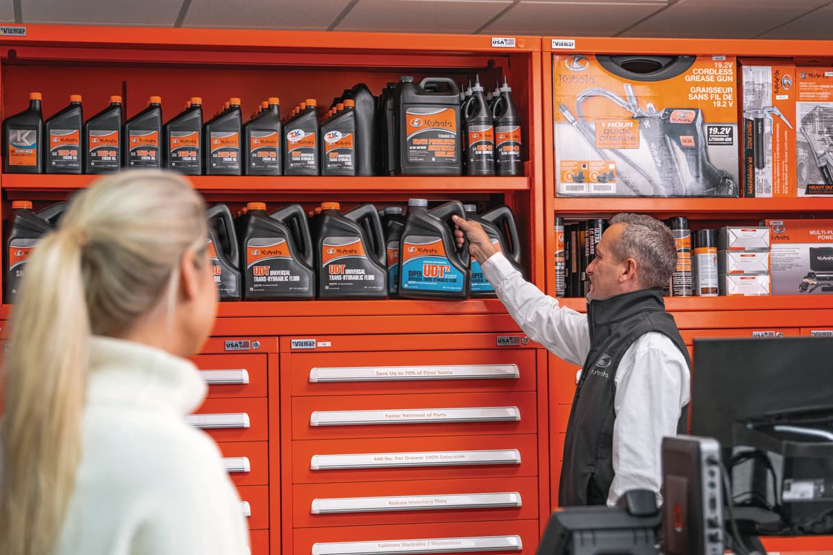 Kubota employee helping a customer find the right oil
