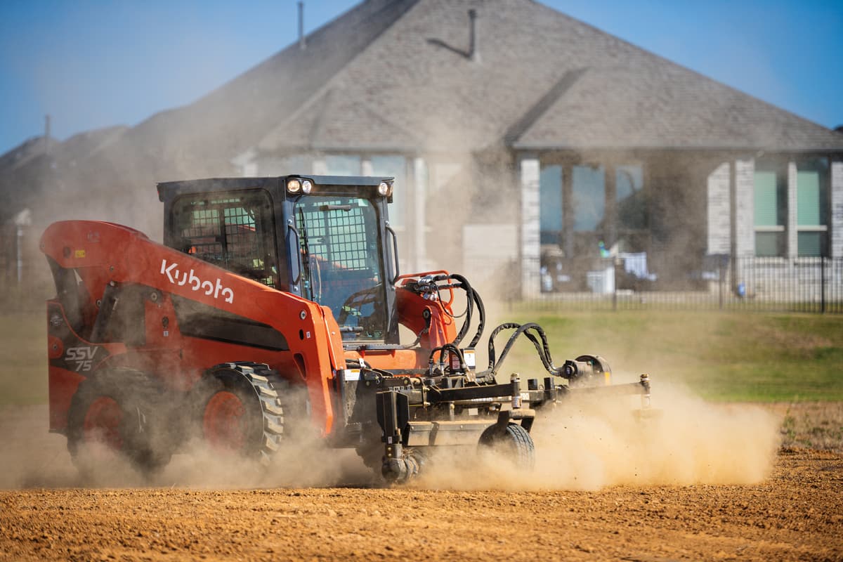 Kubota SSV75 Skid Steer smoothing dirt